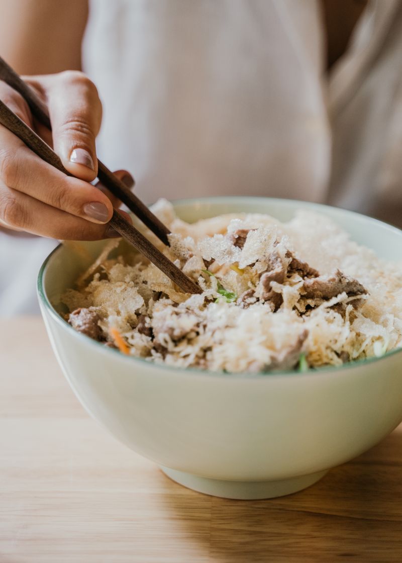 Enjoying a bowl of noodles with chopsticks