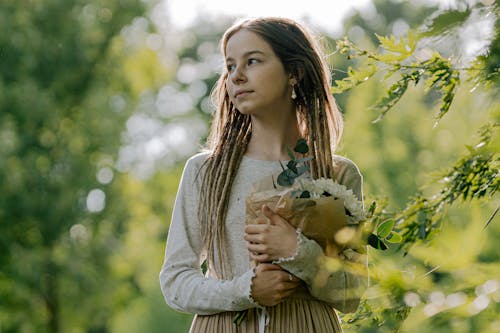 A Woman Holding a Bouquet of Flowers