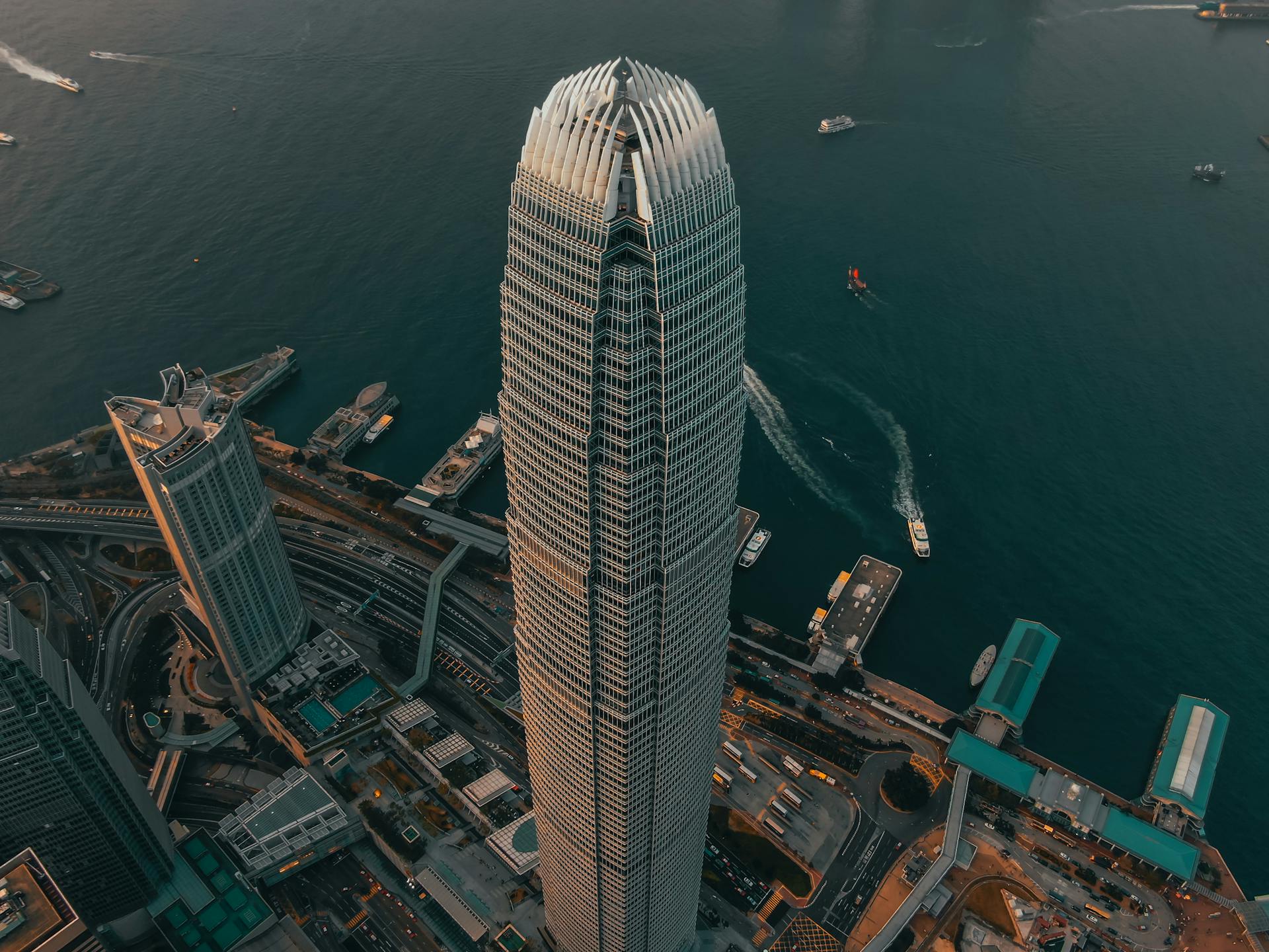 A breathtaking aerial view of a modern skyscraper in Hong Kong overlooking the bustling harbor.