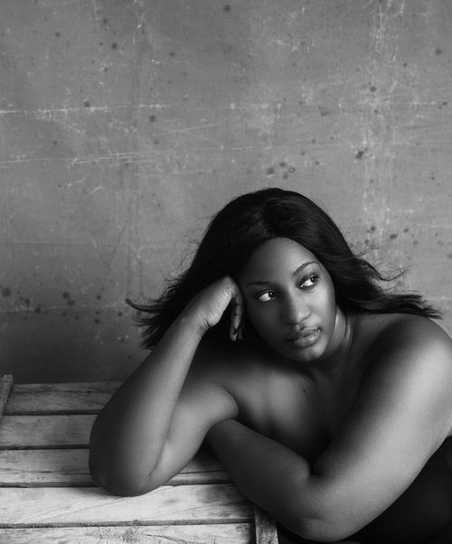 Free Black and white high angle of plump African American female with flowing hair thinking on problem and looking away Stock Photo