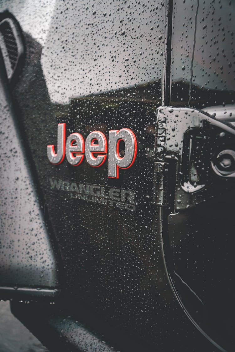 Brand Of Car On Black Surface In Drops