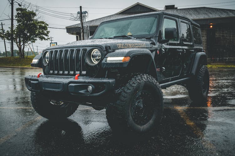 Massive Black Car On Rainy Street