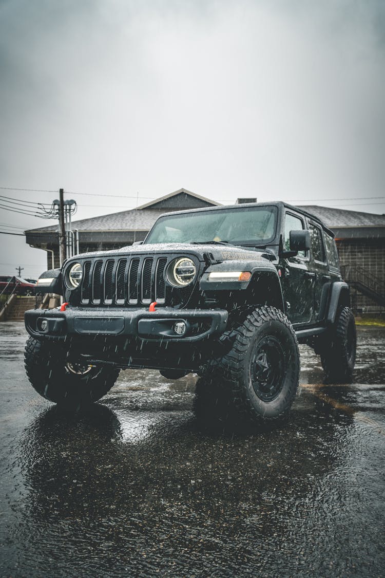 Black Massive Car Parked On Wet Asphalt