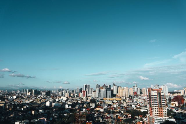 Manila cityscape with modern skyscrapers under a clear blue sky
