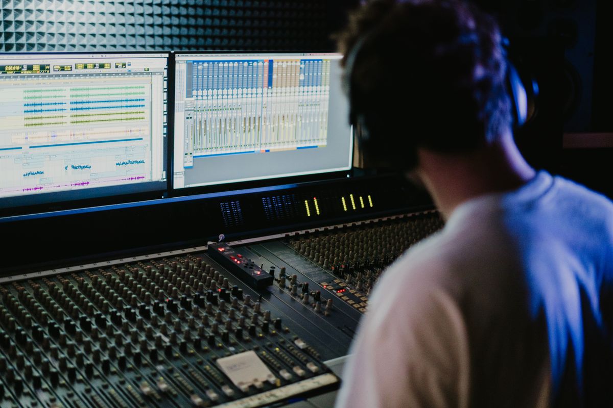Sound engineer at the live mixing console in the control room