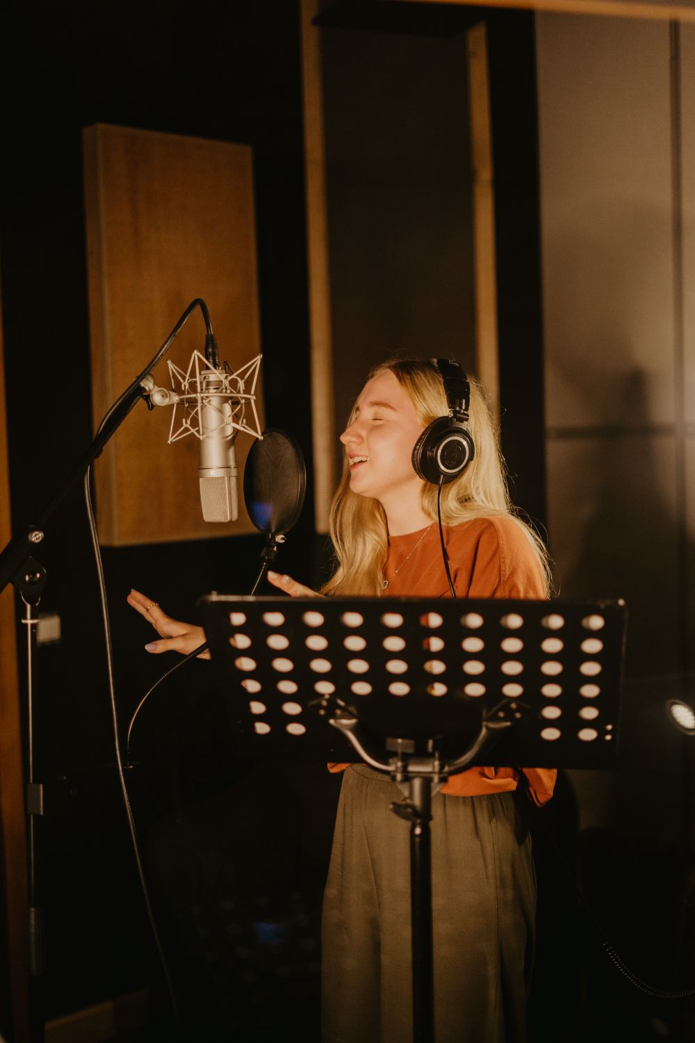 Voice artist performing inside an acoustic recording booth