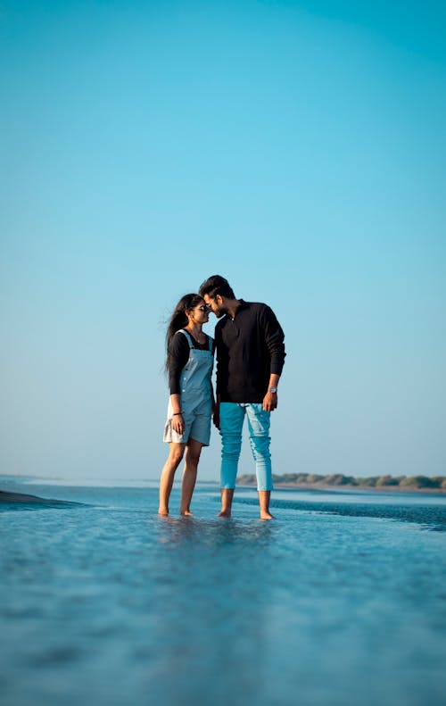 Man and Woman Standing on Seashore