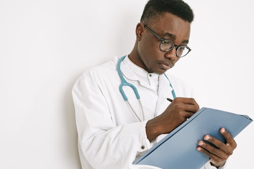 A Doctor Writing on a Folder