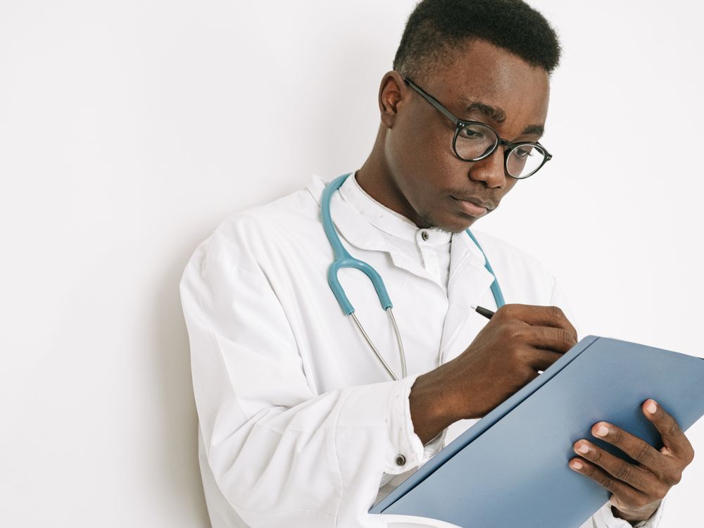 Doctor taking notes on a clipboard