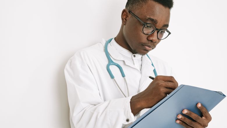 Doctor taking notes on a clipboard