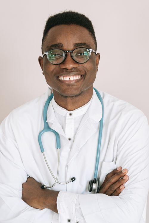 Free Professional African doctor smiling confidently with a stethoscope. Stock Photo