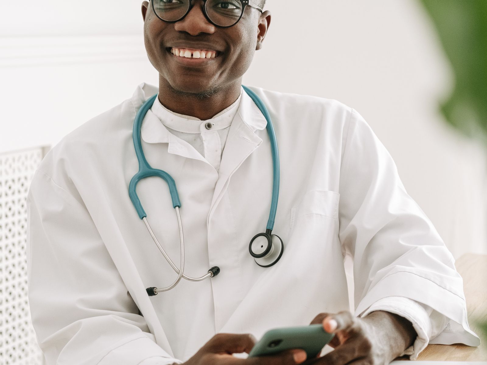 Healthcare professional using a phone or front-desk technology in a modern practice