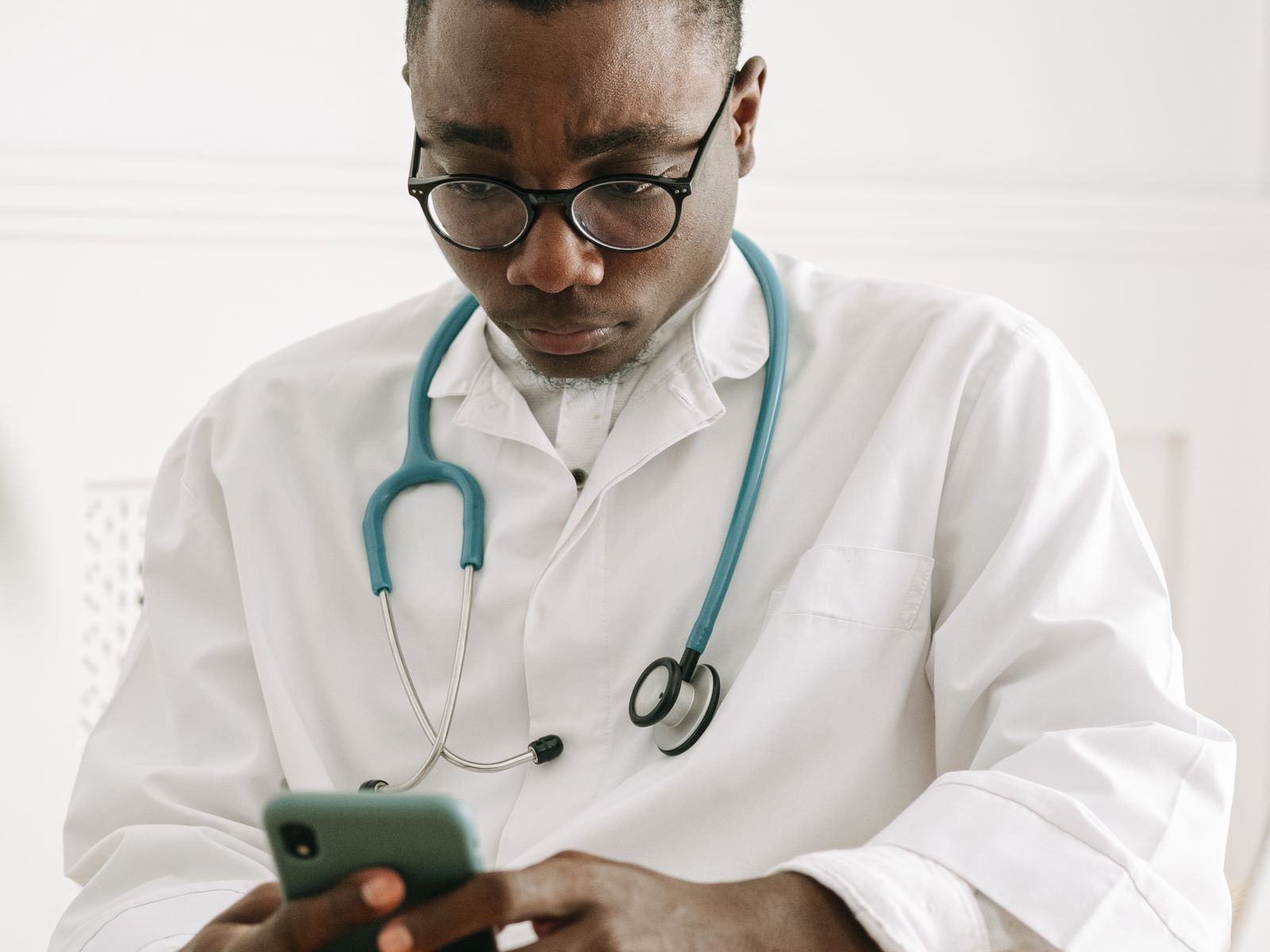Healthcare professional using a phone or front-desk technology in a modern practice