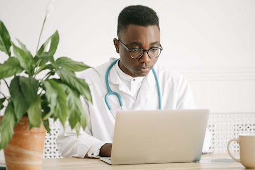 Free A Doctor Working on His Laptop Stock Photo