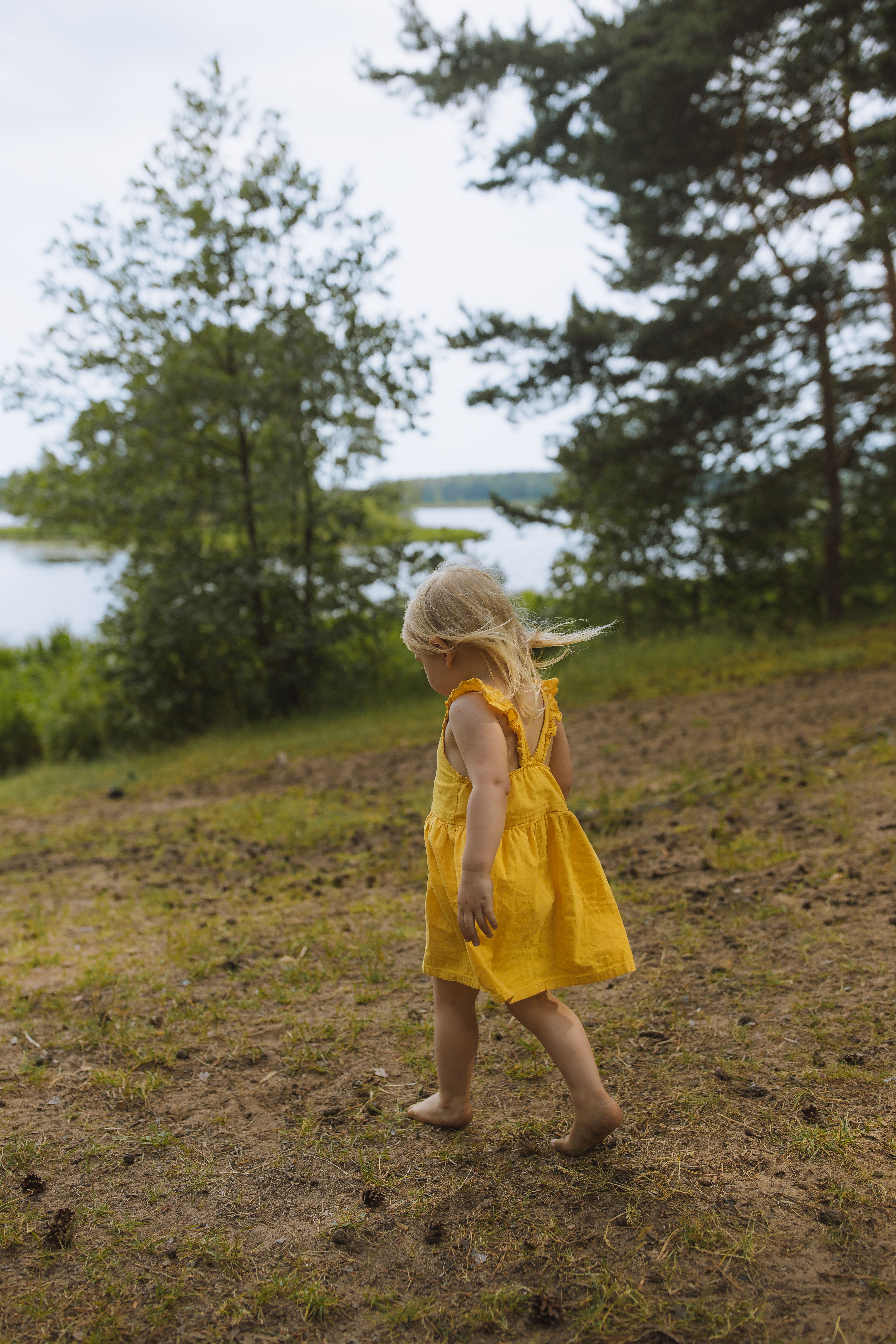 Girl in Yellow Dress Standing on Green Grass Field · Free Stock Photo