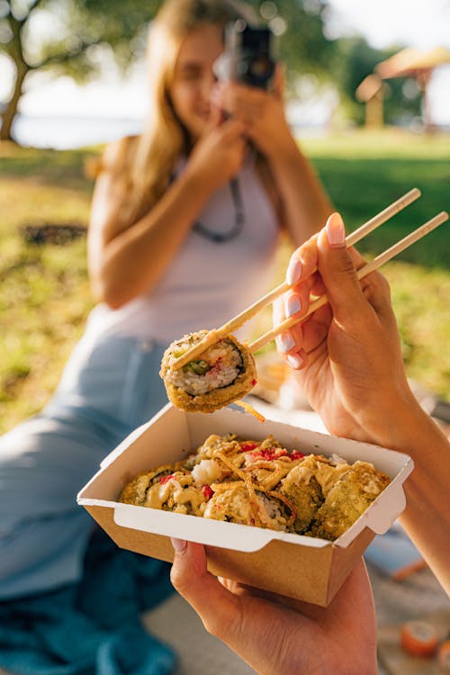 Person Holding Chopsticks