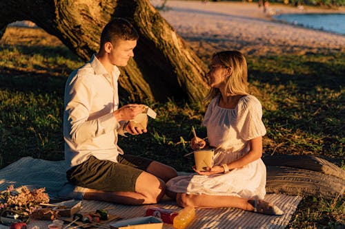 Free A Couple Eating Food in the Picnic Ground Stock Photo