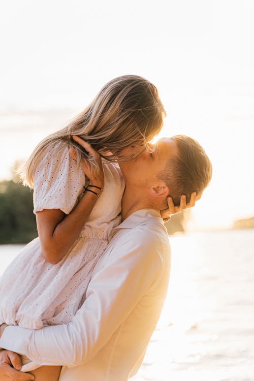 Woman in White Dress Kissing Man