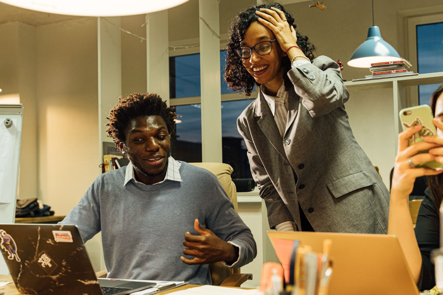 Young professionals collaborating in a cozy office environment, engaging in a productive discussion.