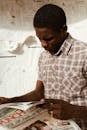 Thoughtful black man reading newspaper
