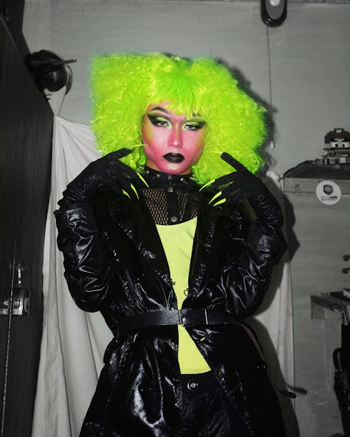 Trendy person in neon wig and bright makeup