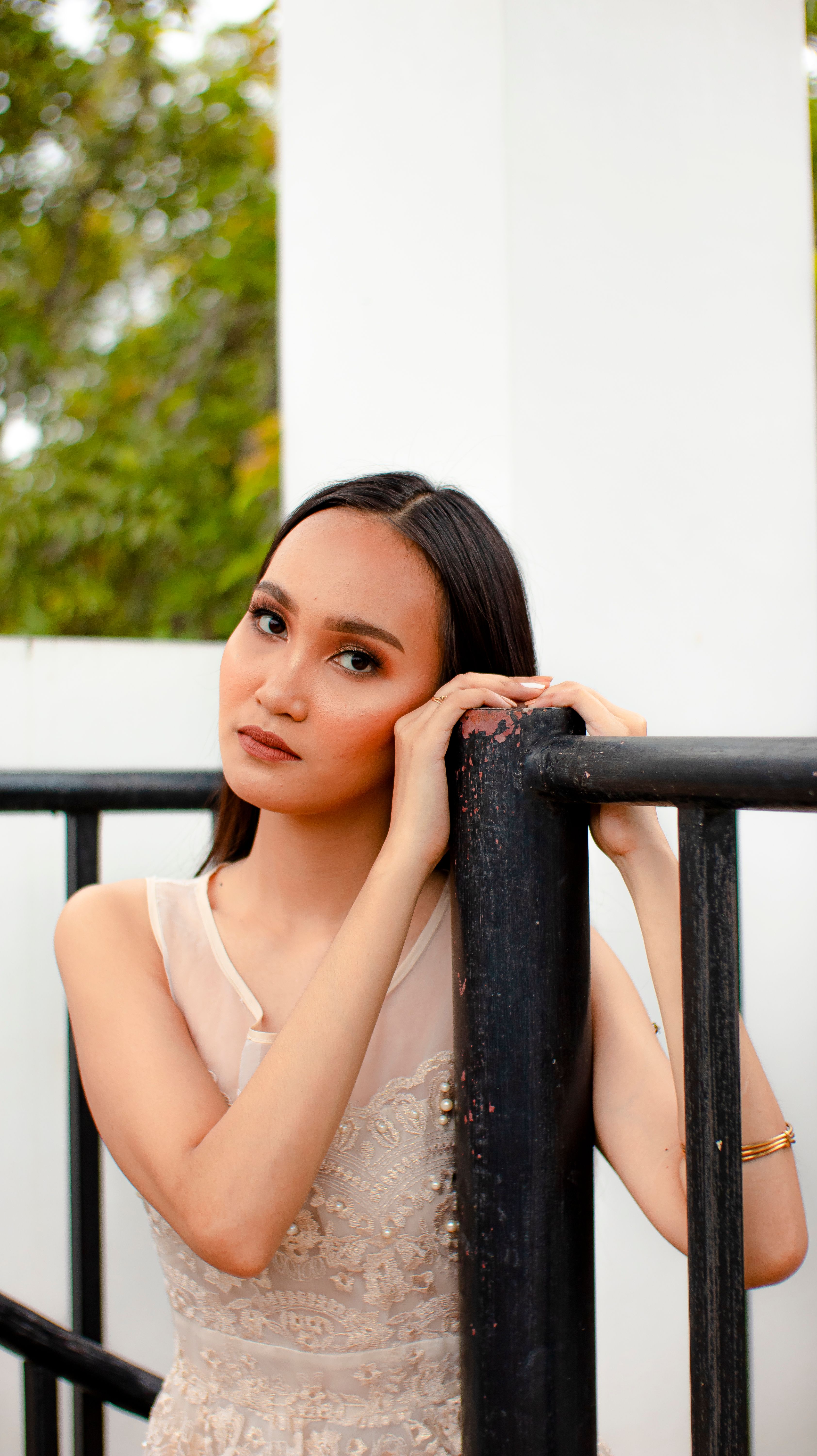 Woman Leaning on Black Metal Railing · Free Stock Photo
