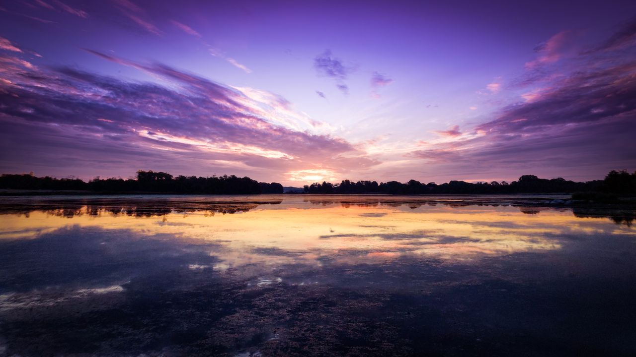serene landscape of a tranquil sunset reflecting on calm ocean waters