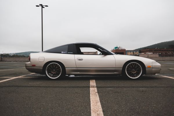 Silver coupe parked on open asphalt, photo by Erik Mclean on Pexels