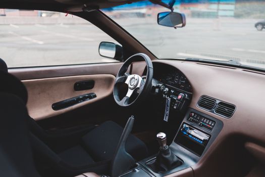 Interior of empty contemporary automobile with view of driver seat and steering wheel and dashboard