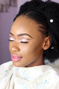 Beautiful portrait of a woman with intricate braids and elegant makeup, eyes closed in serenity.