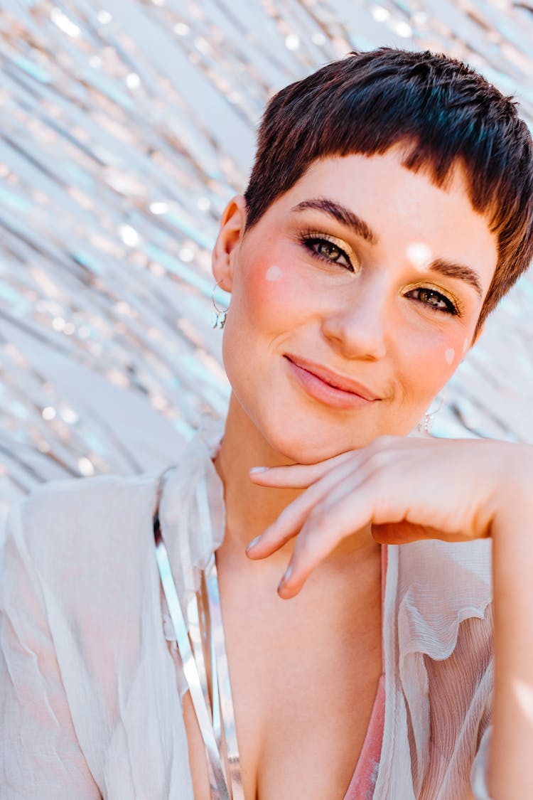 Smiling Woman Near Silver Tinsel