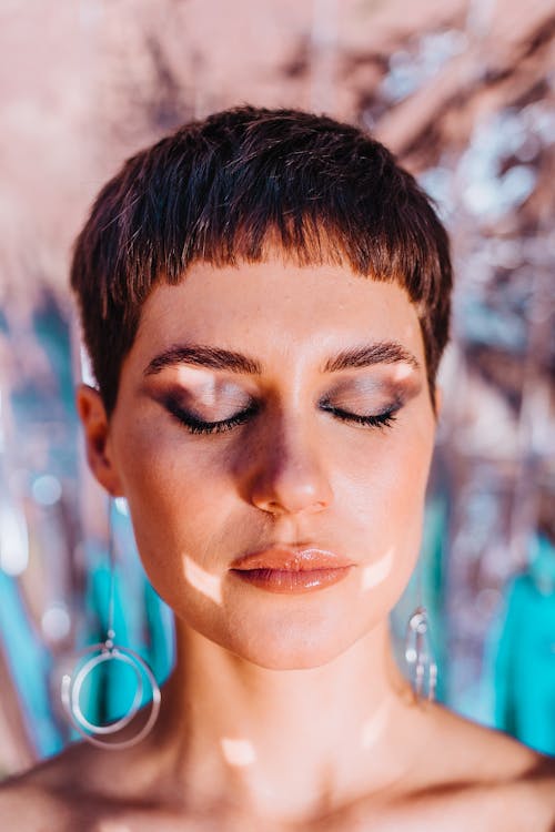 Calm woman with bright glitter on face