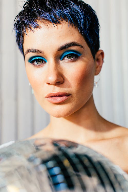 Gentle woman with blue eyeshadow on eyelids