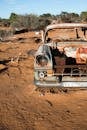 Rusty car abandoned in desert