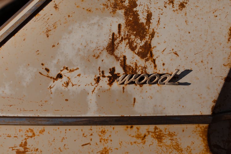 Inscription On Rust Surface Of Old Car