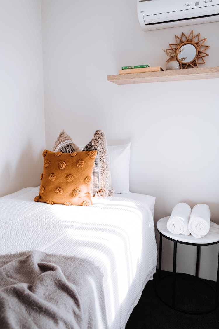 Bed With Pillows In Light Room