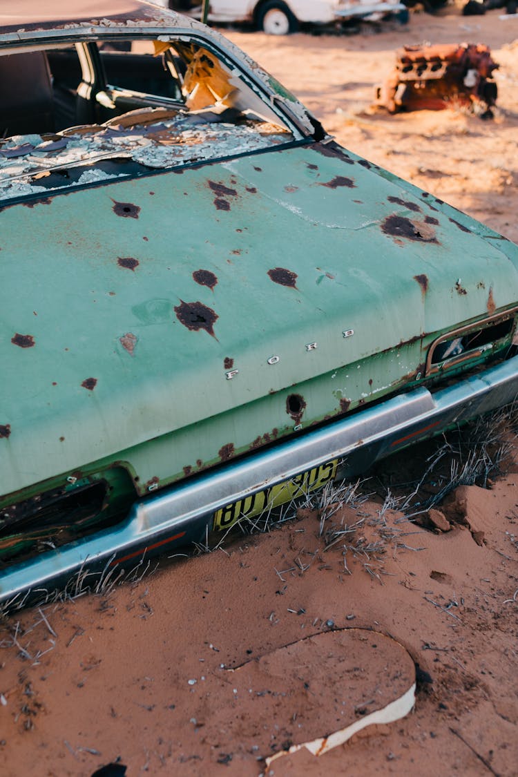 Aged Car With Rusty Bonnet Placed In Countryside