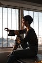 Tranquil woman sitting in solitude near window