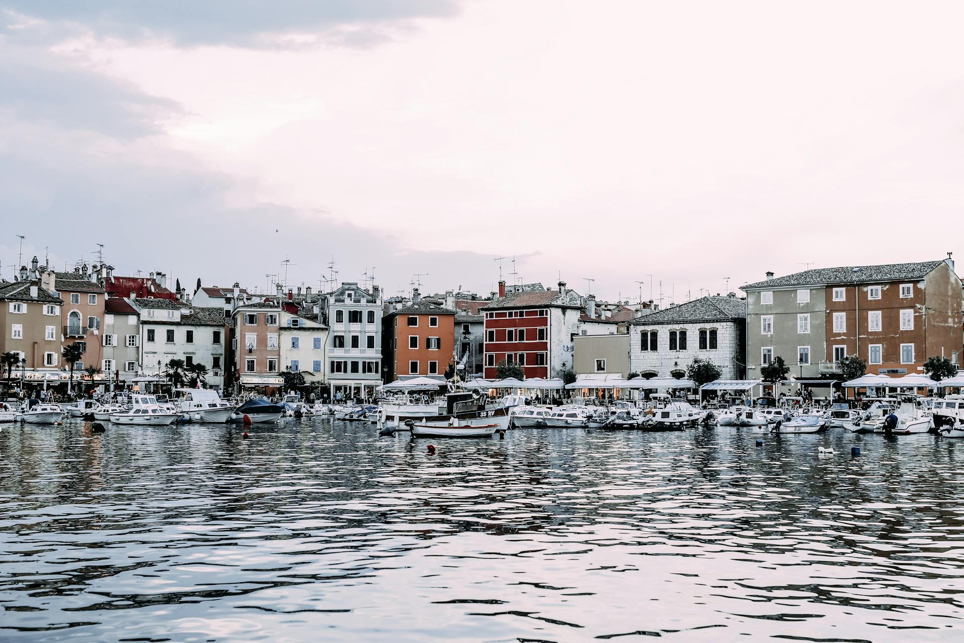 Houses near port with boats in town
