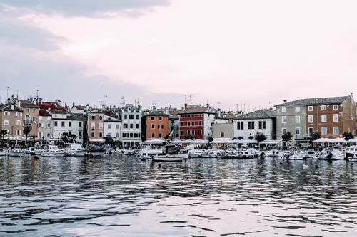 Free Cityscape of small buildings located near harbor with boats in city under clear sky in daytime Stock Photo