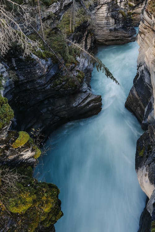 River streaming between rocky mountains with moss