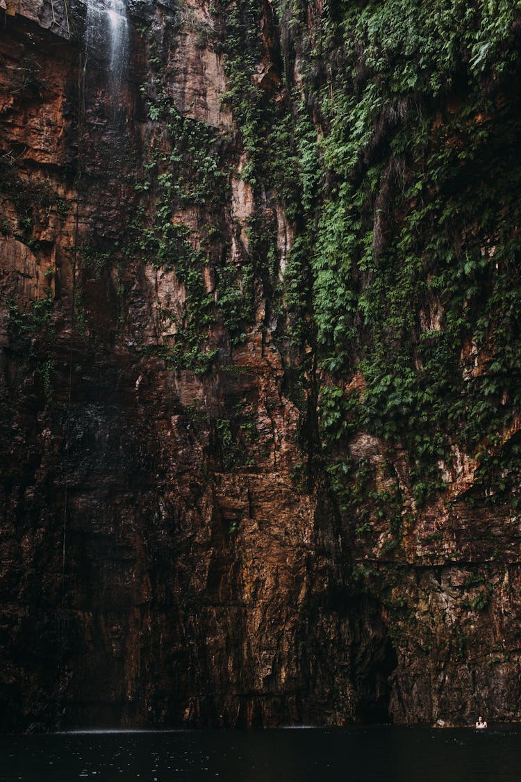 Mountain With Moss Near Lake With Waterfall