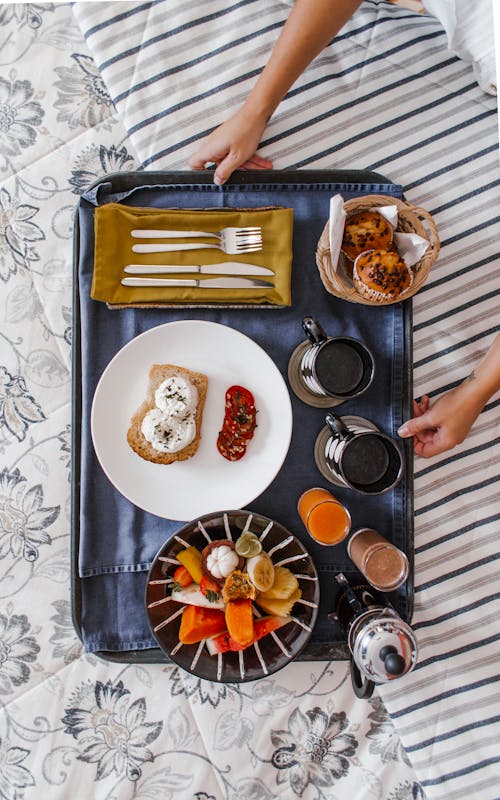 Free Tray with food and drinks on bed Stock Photo