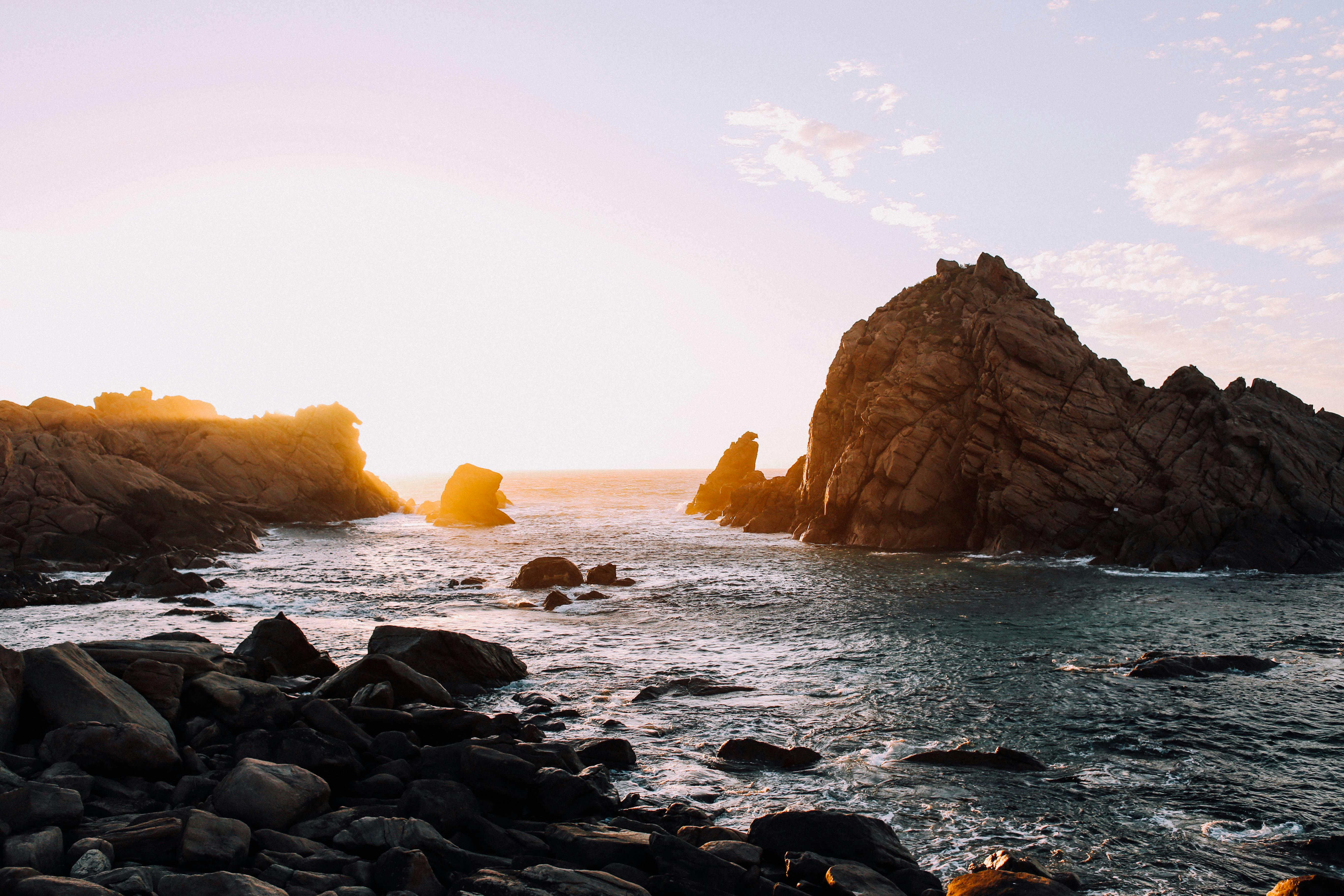 Empty sandy ocean beach and Haystack Rock · Free Stock Photo