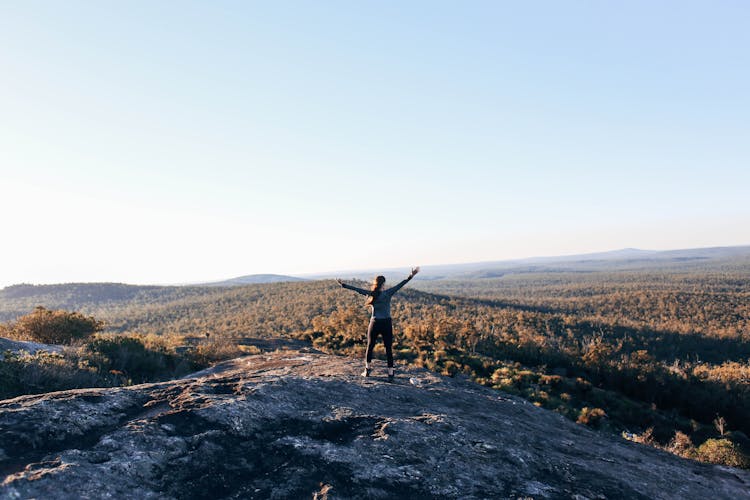 Happy Woman On Edge Of Mountain