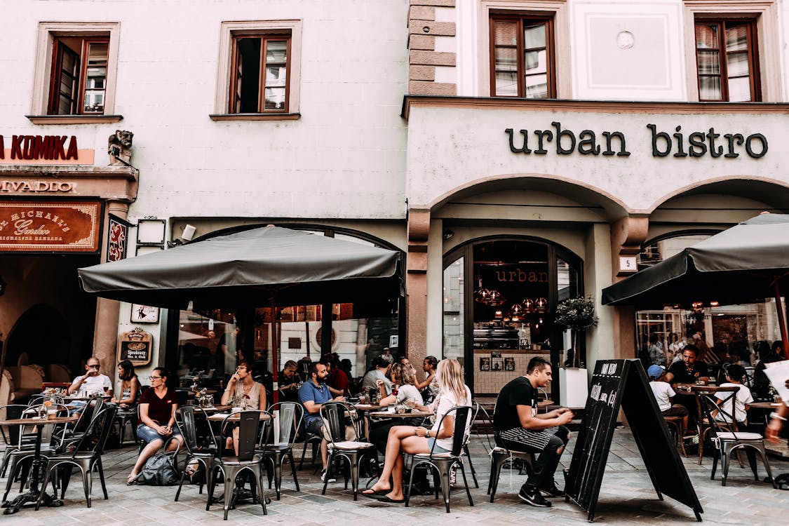 Street cafe with people and tables urban bistro Restaurants