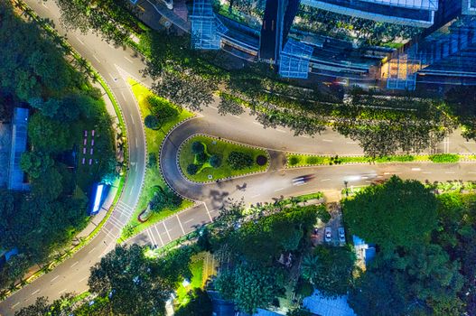 Stunning aerial view of illuminated city streets and buildings in Jakarta, Indonesia at night.