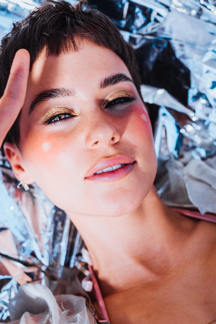 Woman With Golden Eyeshadows In Bright Sun