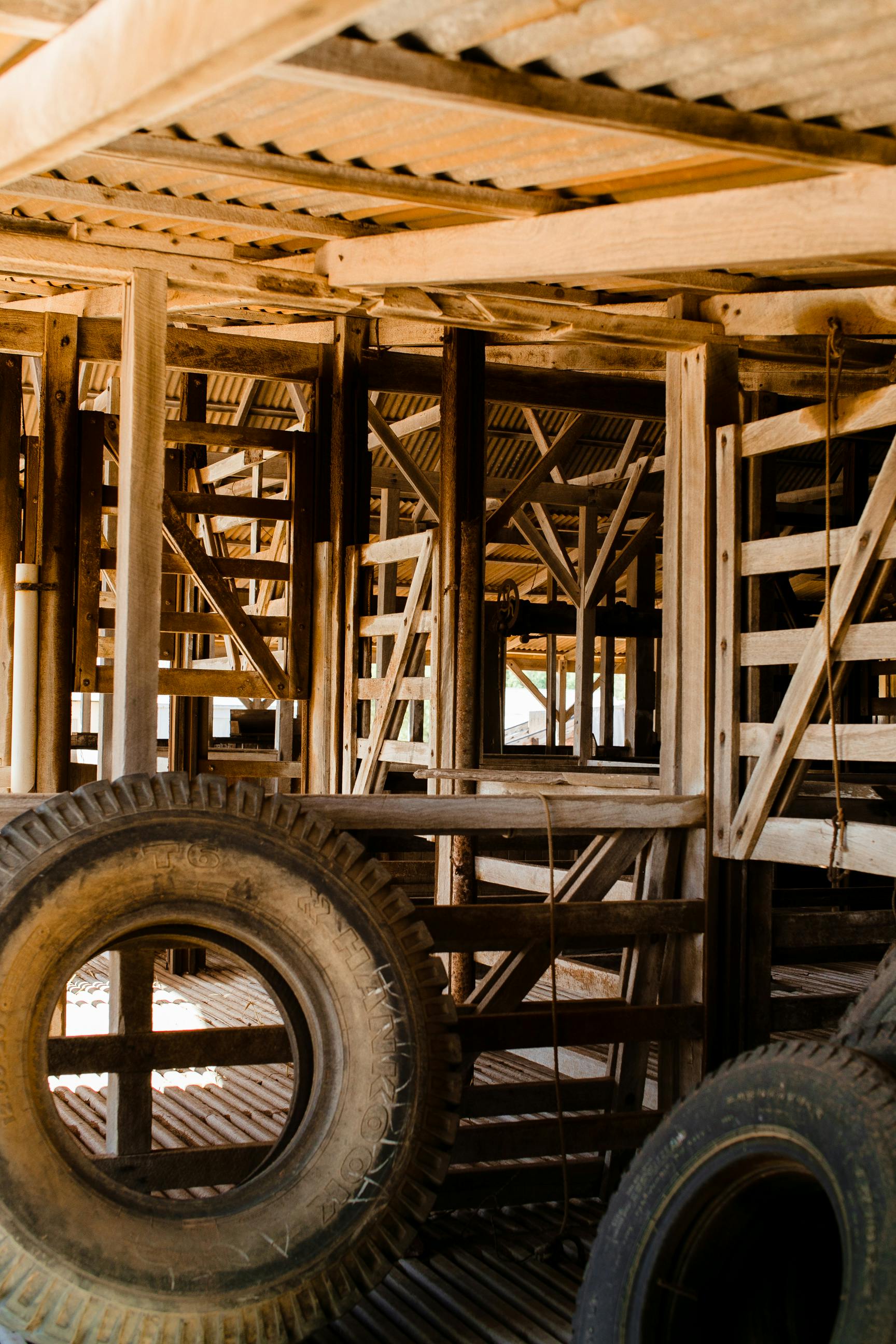 tires in old wooden hangar in sunlight