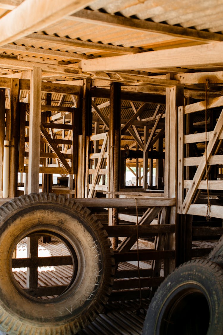 Tires In Old Wooden Hangar In Sunlight